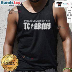 Tom Caron proudly wearing a TC Army metal tank top, showcasing team spirit and style in a vibrant setting.
