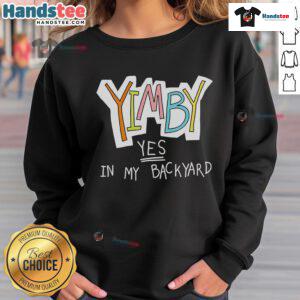 Alt Text: Cozy 'Nice Yimby Yes In My Backyard' sweatshirt displayed on a wooden table, perfect for casual wear and expressing support.