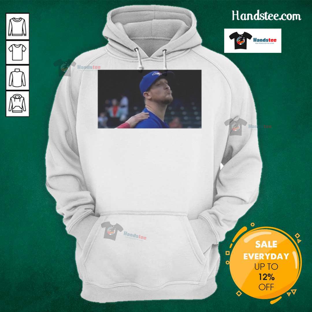 Jeff Hoffman blowing a kiss while wearing a Toronto Blue Jays baseball hoodie, showcasing team spirit.