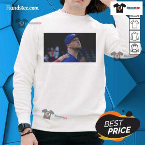 Jeff Hoffman blowing a kiss while wearing a Toronto Blue Jays baseball sweatshirt, showcasing team spirit and style.