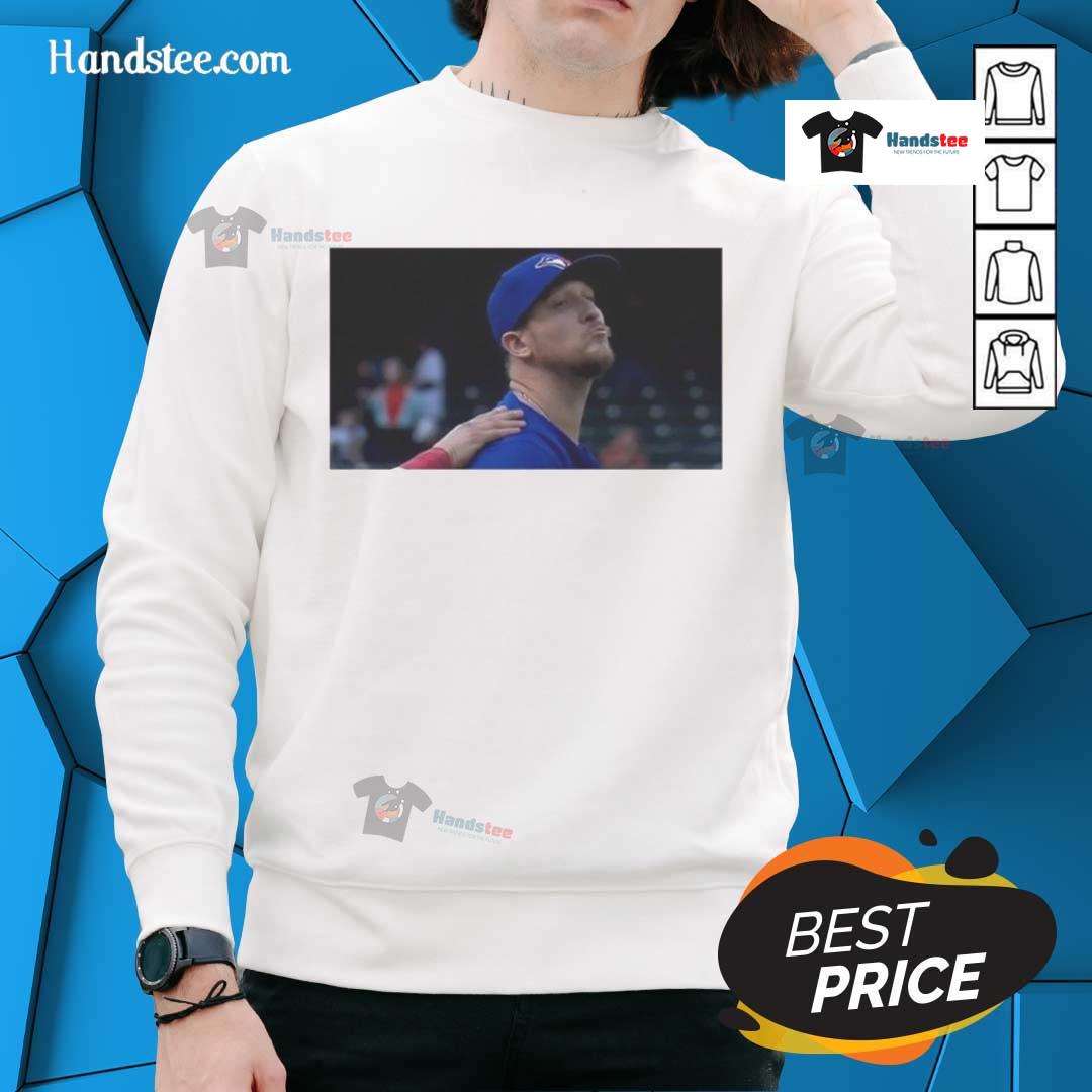 Jeff Hoffman blowing a kiss while wearing a Toronto Blue Jays baseball sweatshirt, showcasing team spirit and style.