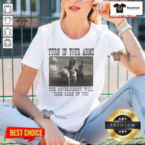 Official Turn In Your Arms Native American Ladies Tee featuring bold graphics promoting government support and care.