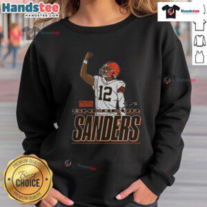 Shedeur Sanders wearing a Cleveland Browns 'Believe' sweatshirt, showcasing team spirit and style.