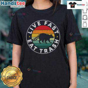 Vintage sunset design featuring a funny raccoon and the phrase 'Live Fast Eat Trash' on a ladies tee.