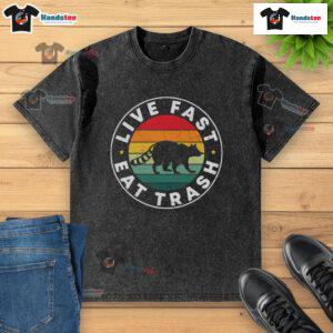 Vintage sunset graphic t-shirt featuring a funny raccoon with the phrase 'Live Fast Eat Trash' for a playful vibe.