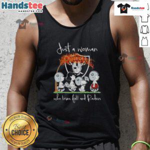 Alt Text: Woman wearing a 'Good Peanuts' Raiders tank top, celebrating fall with a vibrant autumn background.