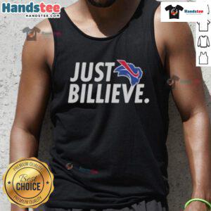 Alt Text: Happy Eric Wood wearing a 'Just Believe' tank top, promoting positivity and motivation in a vibrant outdoor setting.
