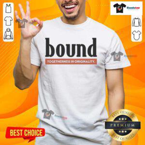 Stylish nice bound red label t-shirt displayed on a wooden surface, showcasing its vibrant color and modern design.