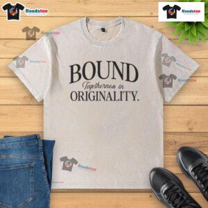 Nice Bound Togetherness in Originality washed t-shirt displayed on a wooden surface, showcasing its unique design and color.