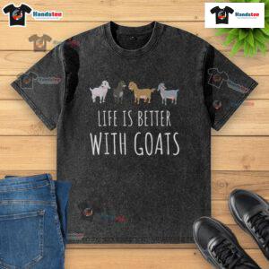 Nice Life is Better with Goats washed t-shirt displayed on a wooden background, showcasing a fun and casual design.