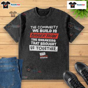 Nice washed t-shirt featuring 'The Community We Build is Bigger Than Us' slogan, promoting unity and togetherness.