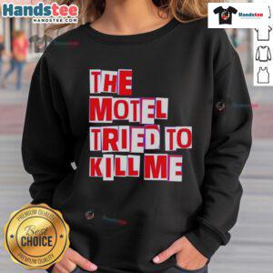 Cozy 'Nice-The-Motel-Tried-To-Kill-Me' sweatshirt displayed on a wooden background, perfect for casual wear.