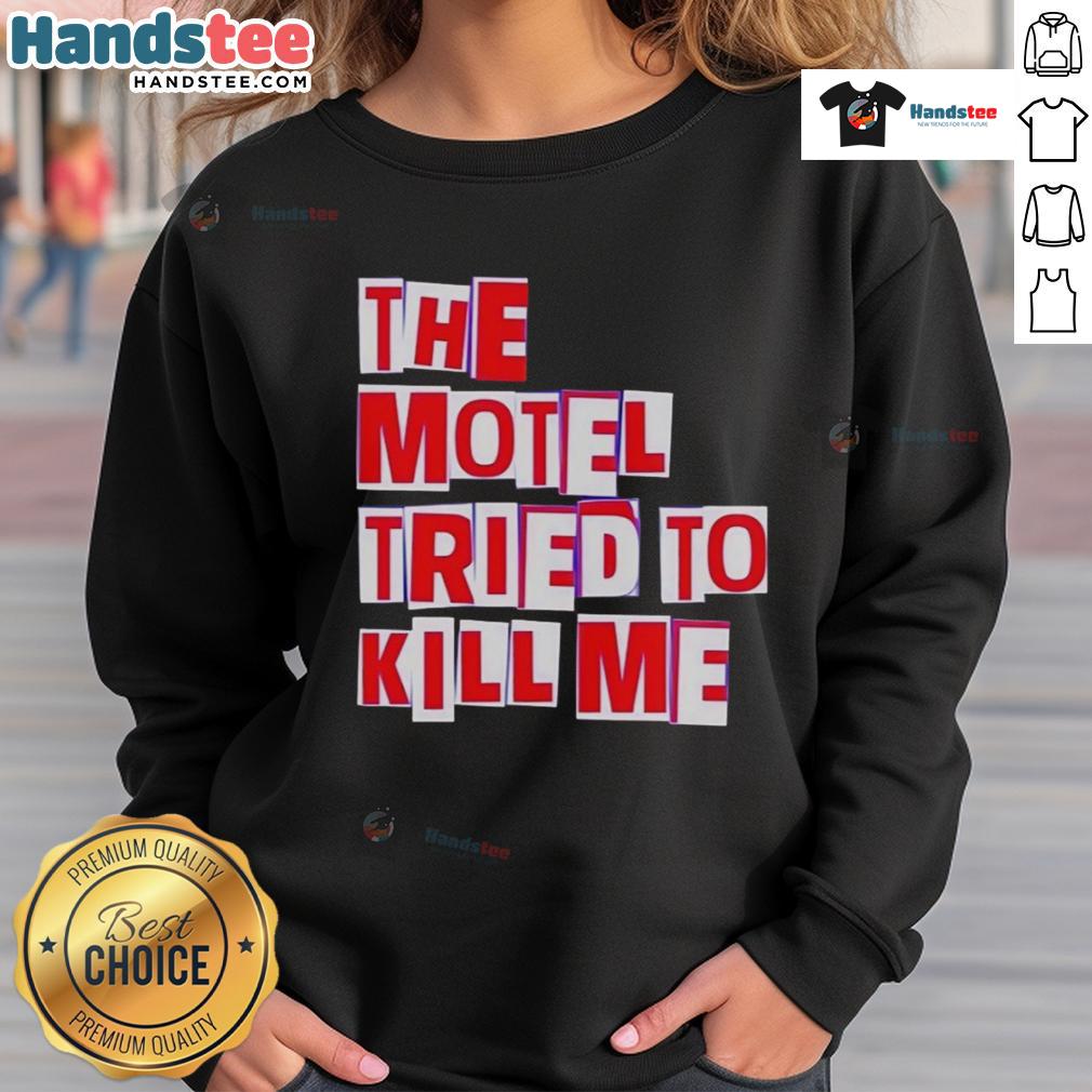 Cozy 'Nice-The-Motel-Tried-To-Kill-Me' sweatshirt displayed on a wooden background, perfect for casual wear.