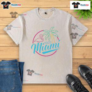 Alt Text: Official Miami Neon Flamingo Logo on a Washed T-Shirt, showcasing vibrant colors and a relaxed, stylish design.