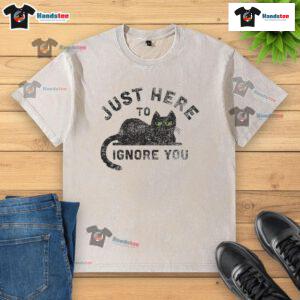 Alt Text: Cute cat on a washed t-shirt with the phrase Just Here To Ignore You, perfect for cat lovers and humorous fashion.