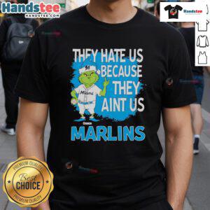 Good Miami Marlins Grinch Christmas T-Shirt featuring 'They Hate Us Ain't Us' design for festive fans.