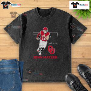 Good Oklahoma Sooners Football John Mateer State Star washed t-shirt displayed on a hanger against a rustic background.