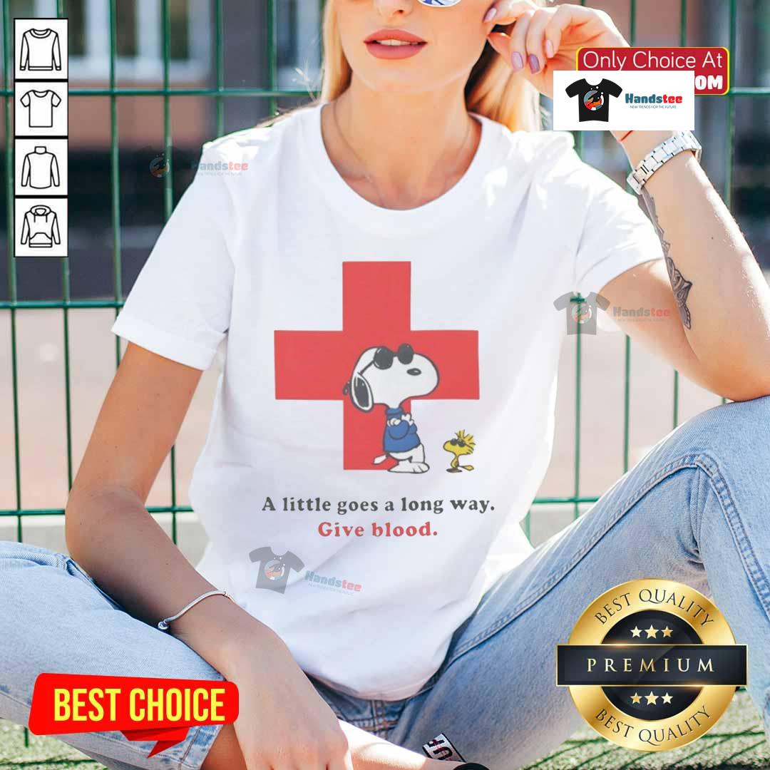 Ladies tee featuring Snoopy and American Red Cross slogan 'A Little Goes A Long Way - Give Blood' with peanuts theme.