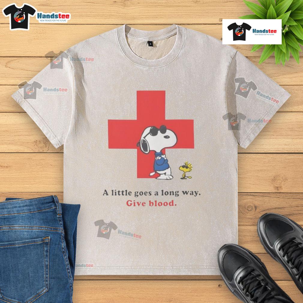 Alt Text: American Red Cross peanuts Snoopy t-shirt promoting blood donation with 'A Little Goes A Long Way' slogan.