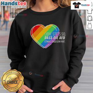 Alt Text: Pride heart sweatshirt with 'Nice Liebe Stets So' design, showcasing support against AfD sentiments.