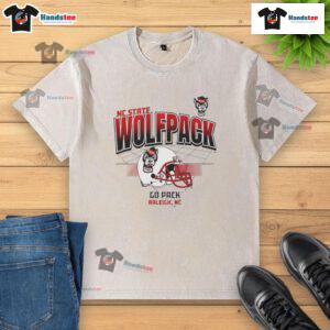 Nice North Carolina State Wolfpack football helmet graphic on a washed t-shirt, showcasing team spirit and style.