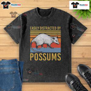Alt Text: Vintage sunset t-shirt featuring the phrase Easily Distracted by Possums with a playful animal design.