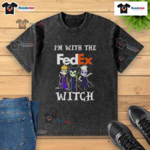 Official 'I'm With The FedEx Witch' Halloween Villains washed t-shirt featuring a spooky design for festive fun.