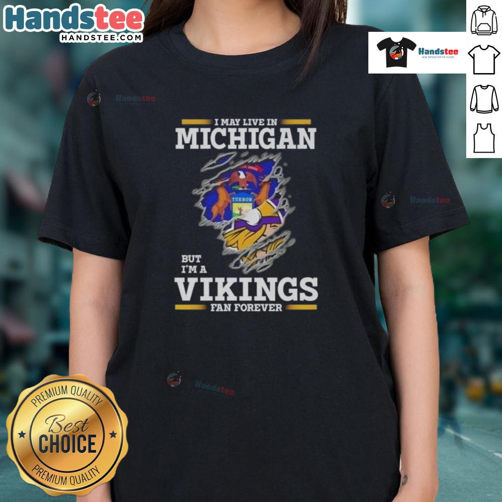 Premium ladies tee featuring 'I May Live In Michigan But I'm A Minnesota Vikings Fan Forever' design.