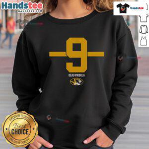 Alt Text: Beau Pribula wearing a stylish 9-stripe sweatshirt supporting Missouri Tigers football team.