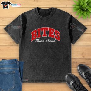 Good Bites Run Club Volume 2 washed t-shirt displayed on a wooden surface, showcasing its casual style and comfort.