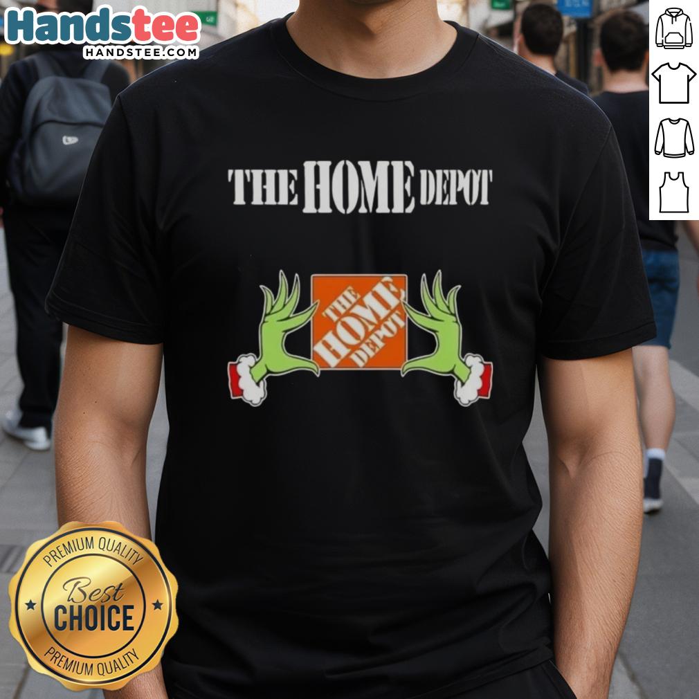 Nice Grinch hands holding a Home Depot Christmas T-shirt, perfect for festive holiday celebrations and gift giving.
