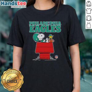 Alt Text: Awesome Philadelphia Eagles Snoopy chilling with football in Peanuts style on a ladies tee shirt design.