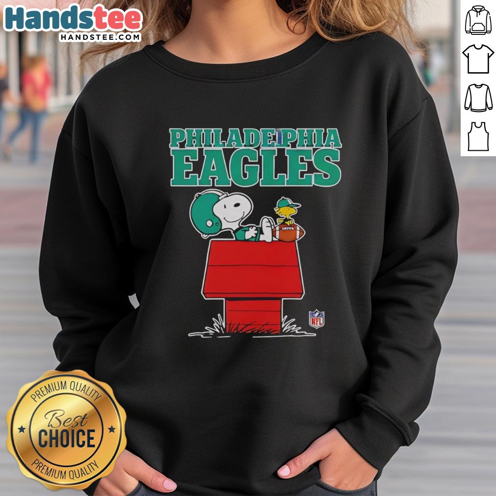 Awesome Philadelphia Eagles Snoopy chilling with a football in Peanuts style sweatshirt, perfect for fans.