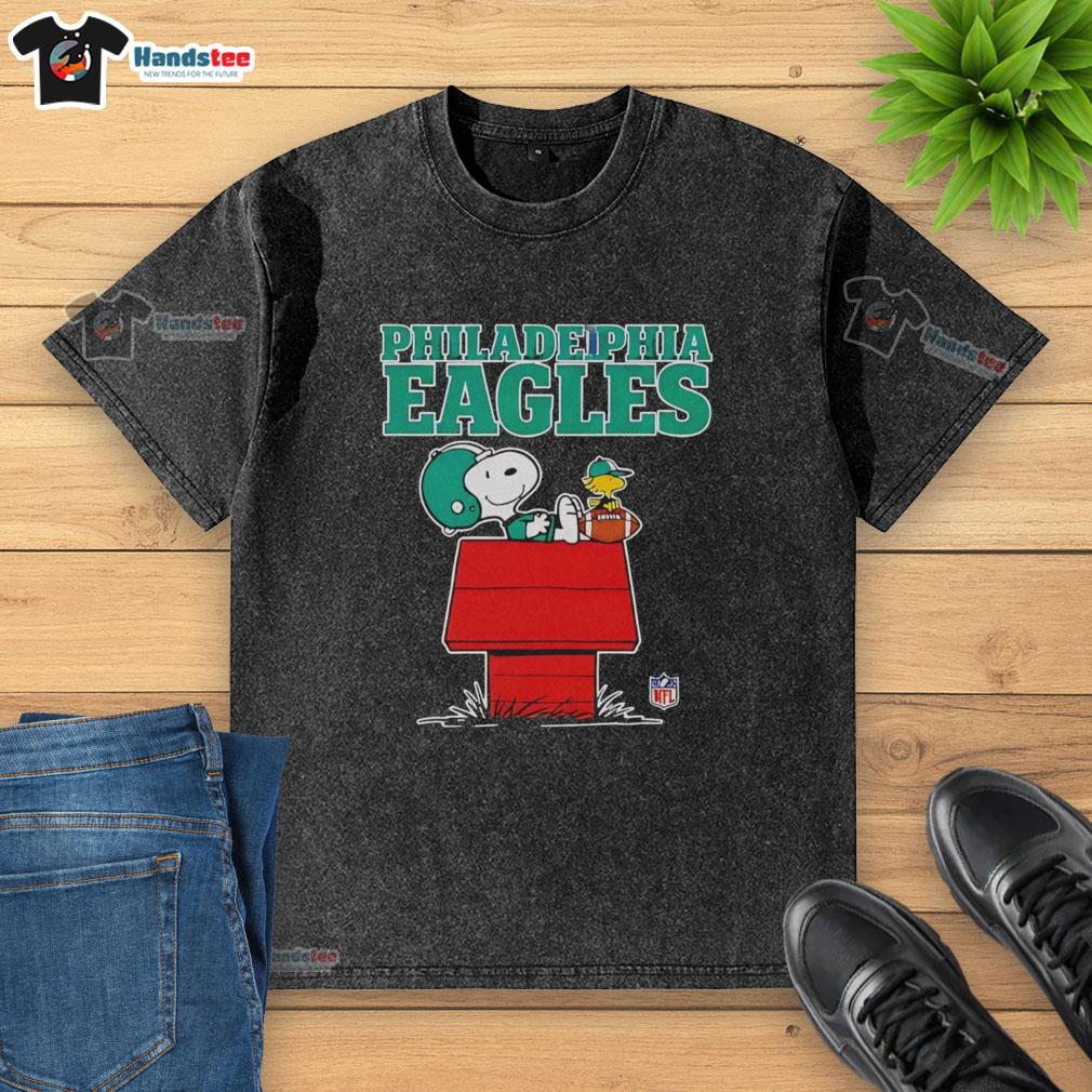 Awesome Philadelphia Eagles Snoopy chilling with a football in Peanuts style on a washed t-shirt design.