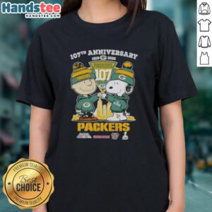 Alt Text: Cute Charlie Brown and Snoopy 107th Anniversary Ladies Tee featuring Green Bay Packers football skyline design.