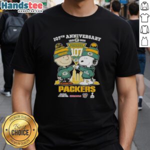 Alt Text: Cute Charlie Brown and Snoopy 107th Anniversary T-Shirt featuring Green Bay Packers football skyline design.