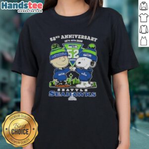 Alt Text: Cute Charlie Brown and Snoopy celebrate Super Bowl 52nd Anniversary 1974-2026 in Seattle Seahawks skyline ladies tee.