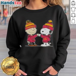 Charlie Brown and Snoopy fist bump on Arizona Cardinals sweatshirt, celebrating friendship and football spirit.