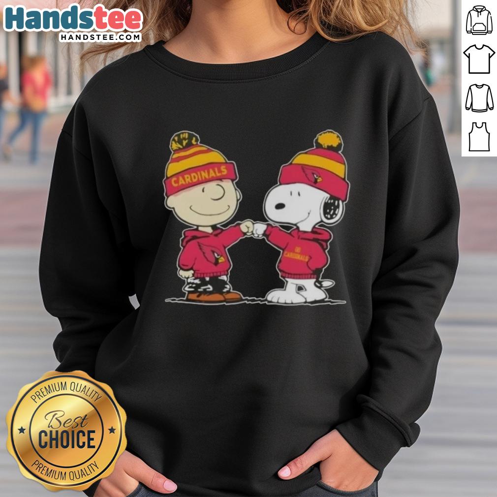 Charlie Brown and Snoopy fist bump on Arizona Cardinals sweatshirt, celebrating friendship and football spirit.