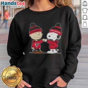 Good Peanuts Charlie Brown fist bump with Snoopy on Atlanta Falcons football sweatshirt, perfect for fans.