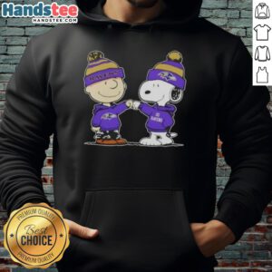 Charlie Brown and Snoopy fist bump in a Baltimore Ravens football hoodie, celebrating friendship and team spirit.