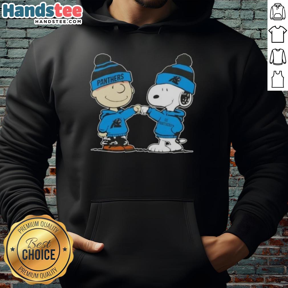 Alt Text: Charlie Brown and Snoopy fist bump in Carolina Panthers football hoodie, celebrating friendship and team spirit.