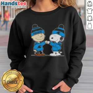 Charlie Brown and Snoopy fist bump on a Carolina Panthers football sweatshirt, showcasing Good Peanuts design.