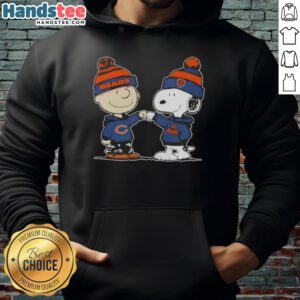 Charlie Brown and Snoopy fist bump in Chicago Bears hoodie, showcasing 'Good Peanuts' football spirit and friendship.