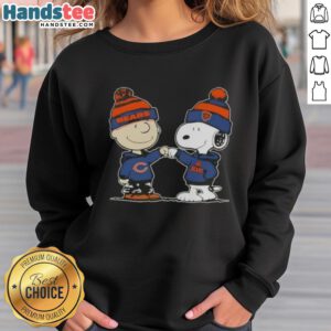 Alt Text: Charlie Brown and Snoopy fist bump in Chicago Bears sweatshirt, celebrating teamwork and friendship with peanuts theme.