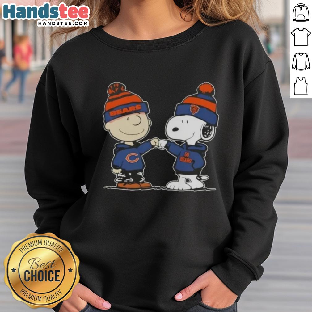 Alt Text: Charlie Brown and Snoopy fist bump in Chicago Bears sweatshirt, celebrating teamwork and friendship with peanuts theme.