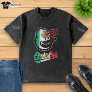 Alt Text: Happy Baltimore Orioles baseball fan wearing a washed t-shirt featuring the Mexican flag design.