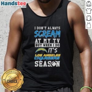 Alt Text: Happy fan wearing a Los Angeles Chargers season tank top, showcasing team spirit while watching a game.