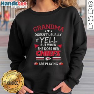 Nice grandma wearing a Kansas City Chiefs sweatshirt, showing her fierce spirit during a football game.