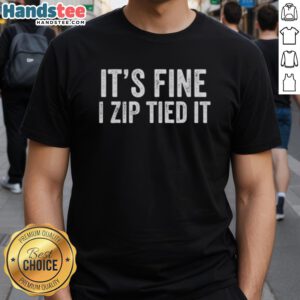 Vintage mechanic car guy t-shirt with 'It's Fine, I Zip Tied It' slogan, perfect for auto enthusiasts and humor lovers.